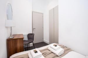 a bedroom with a bed and a desk and a chair at Harley Street Luxury Apartments by City Relay in London +172 photos