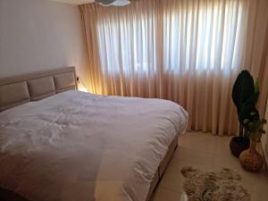 a bedroom with a white bed and a window at Casa Marie - Albir in Albir +55 photos