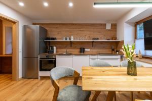 a kitchen with a wooden table and chairs at Lenzlhof in Mariapfarr