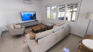a living room with a couch and a tv at Casa Marie - Albir in Albir