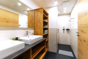 a bathroom with a sink and a shower at Lenzlhof in Mariapfarr