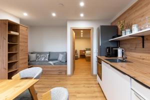 a kitchen and living room with a couch at Lenzlhof in Mariapfarr +36 photos