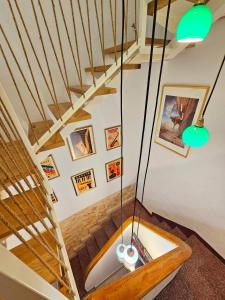 a room with a staircase with green lights at Apartamentos de la Huerta in Alicante