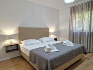 Postel nebo postele na pokoji v ubytování Sunshine Residence Baska 2