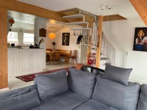 a living room with a couch and a kitchen at Ferienwohnung Holzer am Titisee in Titisee-Neustadt