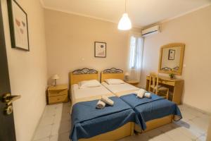 a bedroom with a bed with two towels on it at Sea Esta in Argassi