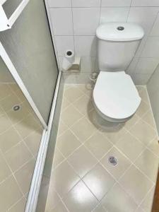 a bathroom with a white toilet in a stall at 3 habitaciones Cabecera del LLano in Bucaramanga