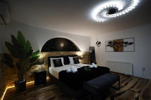 a bedroom with a large bed and a couch at Demiani House in Sibiu
