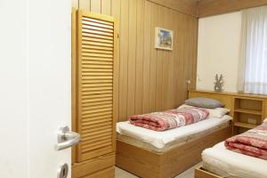 Postel nebo postele na pokoji v ubytování CASA 4 PIOPPI - vista e tranquillità, Dolomiti Affitti