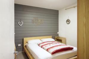 Ένα ή περισσότερα κρεβάτια σε δωμάτιο στο CASA 4 PIOPPI - Cavalese Olimpiadi 2026 Dolomiti Affitti