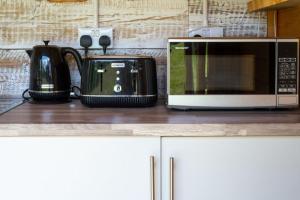 a microwave sitting on top of a kitchen counter at Daisy at Blancas Bell Tents in Ringstead