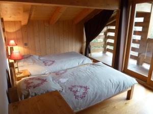 a bedroom with a bed with white sheets and a window at Chalet Le Solaret in Megève