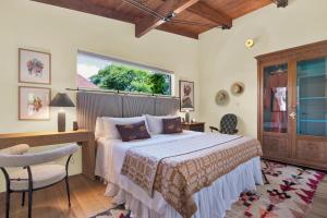 a bedroom with a bed and a desk and a window at The Leona in Lockhart