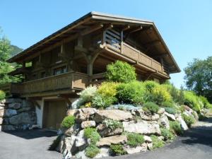 a large building with a balcony on top of a rock at Chalet Le Solaret in Megève