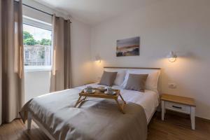 a bedroom with a bed with a table on it at Villa Skarline in Donje Baredine +40 photos