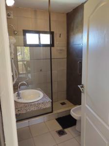 a bathroom with a sink and a toilet at Pauvalén Departamentos in Potrero de los Funes +14 photos