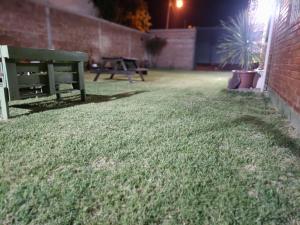 Un banco verde sentado en un patio por la noche. en F R F departamentos turisticos, en San Rafael