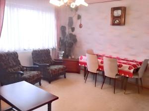a dining room with a red table and chairs at Maison enchanteur à Berrwiller avec jardin paisible in Berrwiller +12 photos