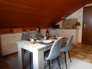 a kitchen with a wooden table with chairs and a counter at Cuore Verde Apartment in Gerra Verzasca