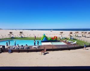 a group of people playing in a pool at the beach at Chacras del Mar 4x4 in Mar Azul