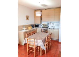 a kitchen with a table and a table and chairs at Residenza Paradiso in Agra