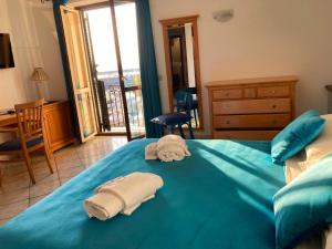 Letto o letti in una camera di B&B L'Approdo