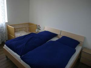 a bedroom with a bed with blue pillows on it at Ferienhof Hirschfeld in Pfalzgrafenweiler