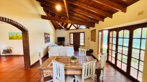 a dining room with a wooden table and chairs at La Casa Nostra in Río Cuarto