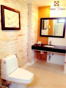 a bathroom with a toilet and a sink at Baan Paan Hua Hin in Hua Hin