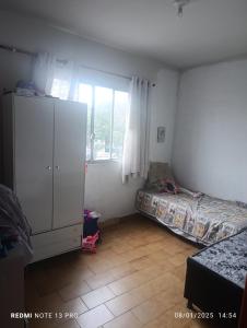 Ένα ή περισσότερα κρεβάτια σε δωμάτιο στο Apartamento Itapuã