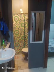 a bathroom with a white sink and a toilet at Casa meu canto in Lençóis