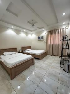 a bedroom with two beds and a ladder in it at Cozy 2-Bedroom Apartment in Batha Quraish in Makkah