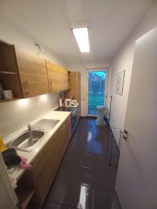 a small kitchen with a sink and a window at Monteur- Ferienwohnung für 5 Pers Gartenhaus in Märkisch Buchholz