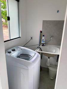 a small bathroom with a sink and a toilet at Suíte Lençóis in Lençóis +5 photos