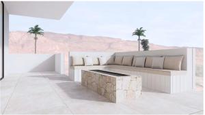 a living room with a couch and palm trees at The Oasis Utah at Desert Color (by Ember Stays) in St. George