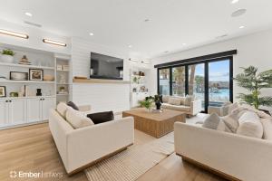 a living room with two couches and a tv at Deja Blue at Desert Color by Ember Stays in St. George