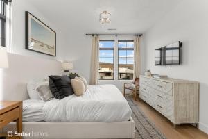 a white bedroom with a bed and a dresser at Deja Blue at Desert Color by Ember Stays in St. George +38 photos