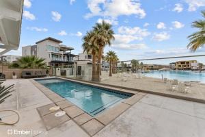 a swimming pool with palm trees and a building at Deja Blue at Desert Color by Ember Stays in St. George