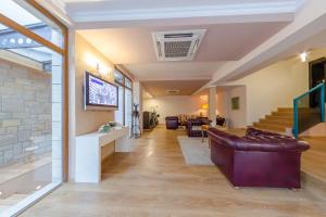 a living room with a couch and a staircase at Hotel Studio in Veliko Tŭrnovo