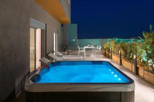 a hot tub on the balcony of a house at Rhodes Skyline Suite with out Door Jacuzzi Sea View in Ixia