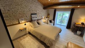 a bedroom with a large bed in a room at Chambres d'hôtes Les Rozières in Le Bourdet