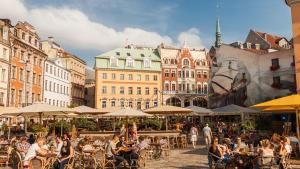 a group of people sitting at tables in a city at Luxury and Romance in Old Town in Rīga