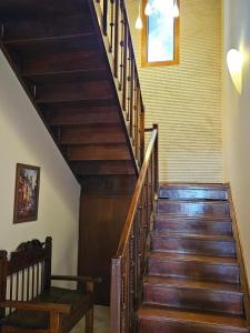 a wooden staircase in a house with a bench at Casa Garay Hotel 658 in Asuncion