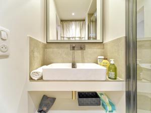 a bathroom with a white sink and a mirror at Hyper Centre - Charming duplex - Luxury - Reversible air conditioning - 10 mins from Place MASSENA in Nice +27 photos