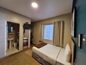 Cama ou camas em um quarto em Hotel Residencial Alfa
