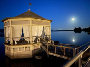 a gazebo on a dock on a lake at night at Lovely Versilia in Torre del Lago Puccini