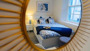 a bedroom with a bed and a mirror at Cardiff City Centre - Luxury Apartments in Cardiff