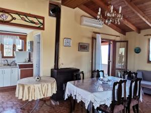 a dining room with a table and a kitchen at Ελαια in Marathopolis +12 photos