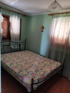 a bedroom with a bed with a quilt on it at Ελαια in Marathopolis