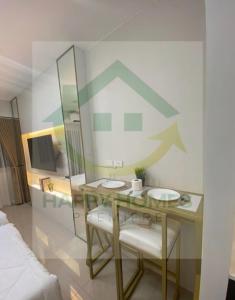 马尼拉Stunning Hotel Feels at Shore的一间设有一张桌子和两把椅子的房间,墙上有一张图表